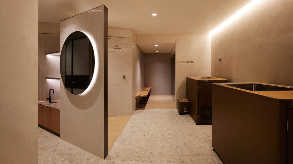 modern interior, earth tones, stone, terracotta, limewash, ice bath, shower niche, backlit circular mirror, marble, finger tiles